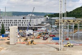 Die Bauarbeiten schreiten voran: Im Vordergrund die Baustelle des neuen Parkhauses. Links im Bild die Gebäude des neuen Bauabschnitts. (Foto: UKJ / Szabó)